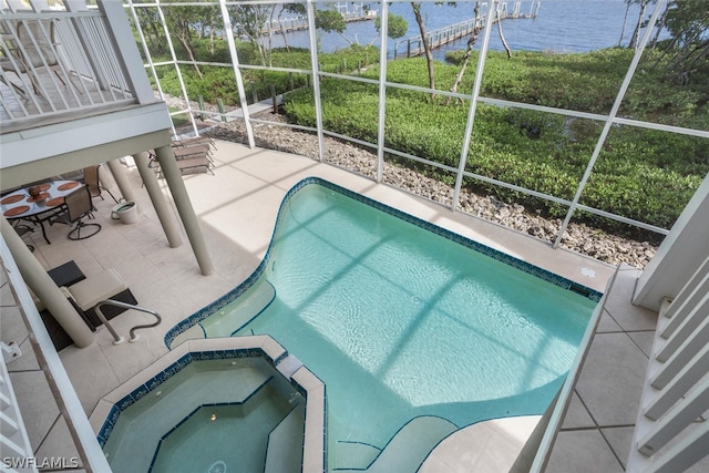 view of swimming pool featuring a patio area and a water view