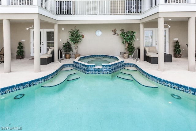 view of swimming pool with a patio area and an in ground hot tub