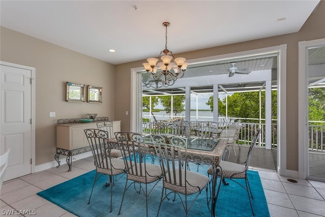 tiled dining room with a notable chandelier and plenty of natural light