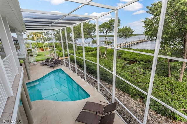 view of swimming pool featuring a patio, a lawn, and a water view