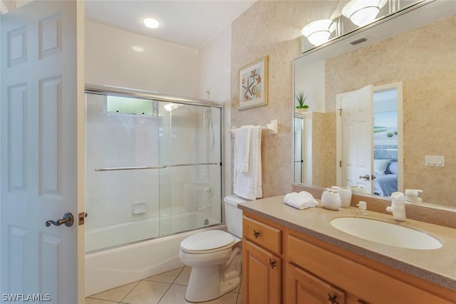 full bathroom featuring tile floors, bath / shower combo with glass door, oversized vanity, and toilet