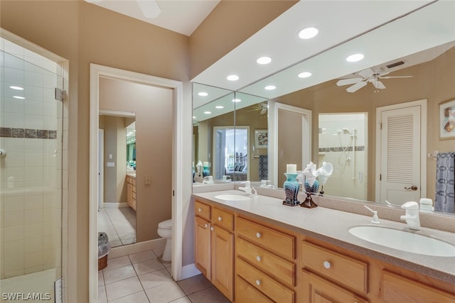 bathroom with dual vanity, ceiling fan, tile flooring, and toilet