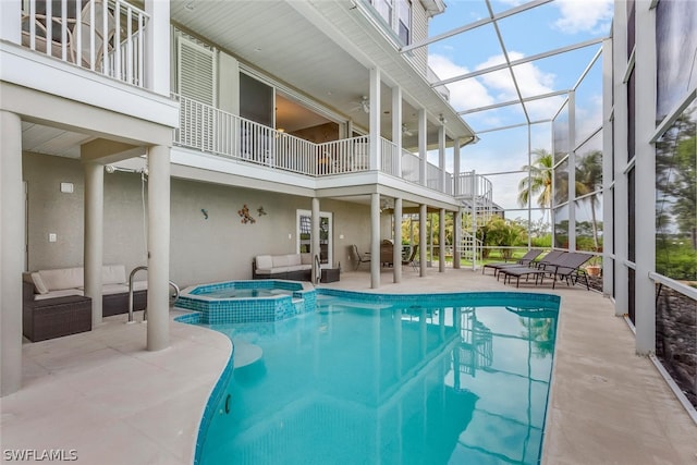 view of swimming pool featuring an in ground hot tub and a patio area