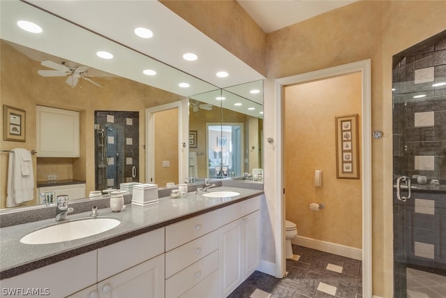 bathroom featuring double sink vanity, toilet, ceiling fan, tile flooring, and walk in shower