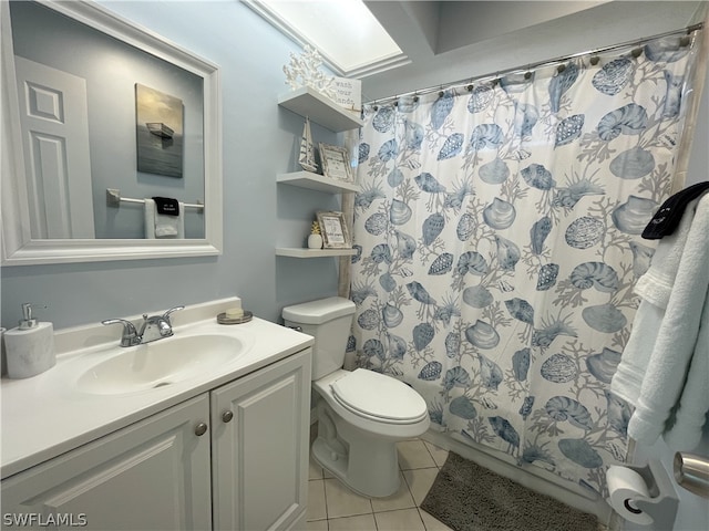 bathroom featuring toilet, tile flooring, and large vanity