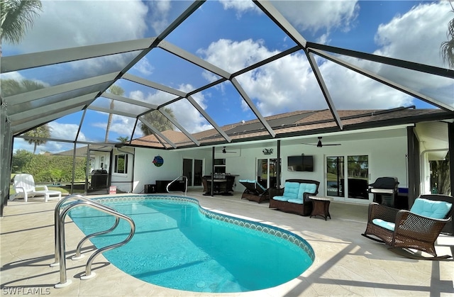 view of swimming pool featuring a patio area, ceiling fan, glass enclosure, outdoor lounge area, and a grill