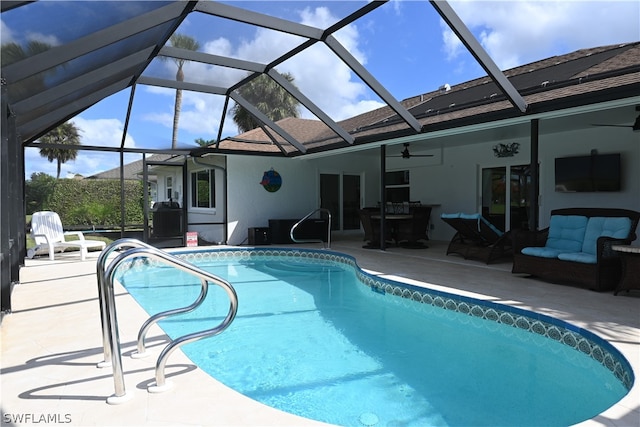 view of swimming pool featuring a patio, ceiling fan, and a lanai