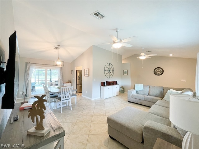 living room featuring ceiling fan, light tile floors, and lofted ceiling