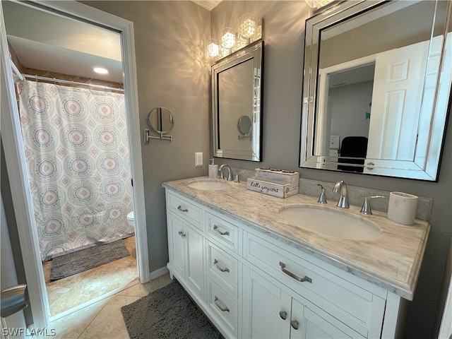 bathroom featuring toilet, tile floors, and dual bowl vanity