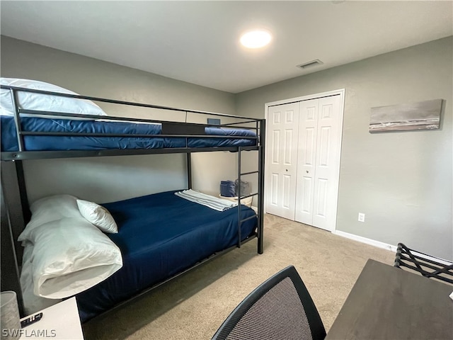 bedroom featuring light carpet and a closet