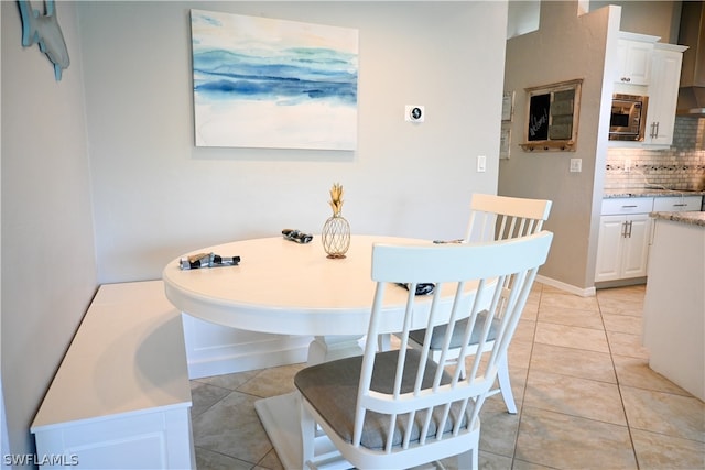 dining space featuring light tile floors