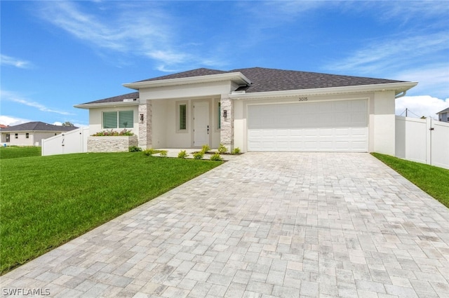 prairie-style house with a garage and a front lawn