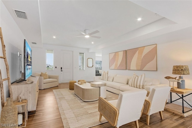 living room with ceiling fan and hardwood / wood-style flooring