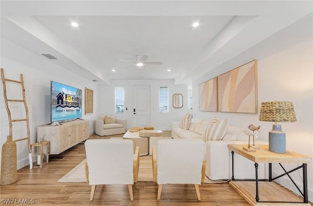 living room with light hardwood / wood-style flooring and ceiling fan