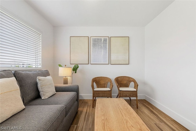 sitting room with hardwood / wood-style flooring