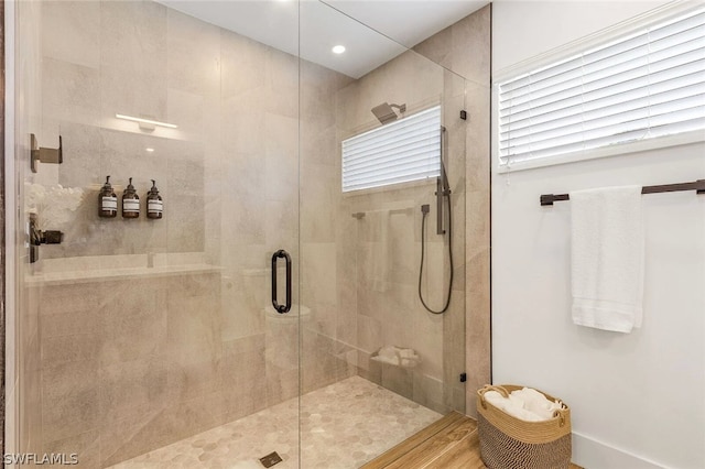 bathroom with a shower with shower door