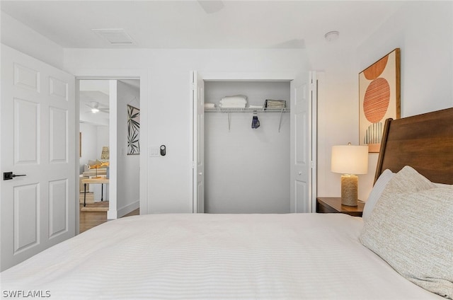 bedroom featuring wood-type flooring and a closet