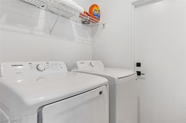 clothes washing area featuring independent washer and dryer