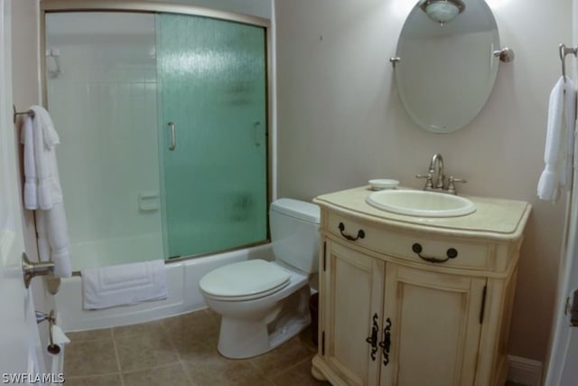 full bathroom with vanity, toilet, and combined bath / shower with glass door