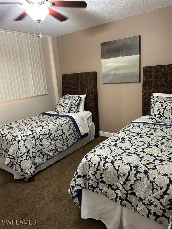 carpeted bedroom with a textured ceiling and ceiling fan