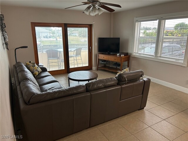 living room with light tile patterned floors and ceiling fan