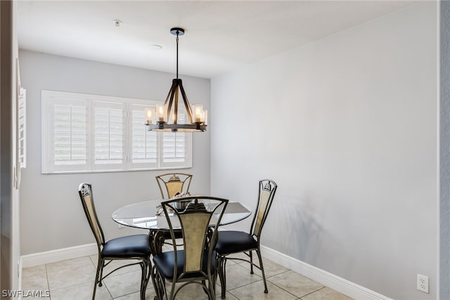 tiled dining area featuring a notable chandelier