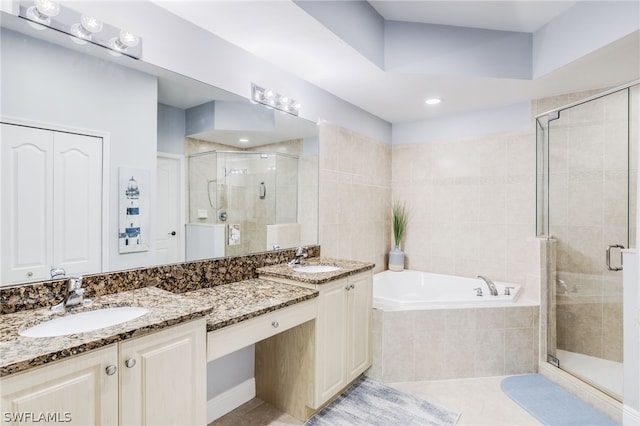 bathroom featuring independent shower and bath, tile patterned floors, and vanity