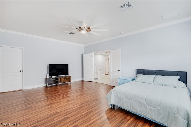 bedroom with ceiling fan, hardwood / wood-style flooring, and ornamental molding