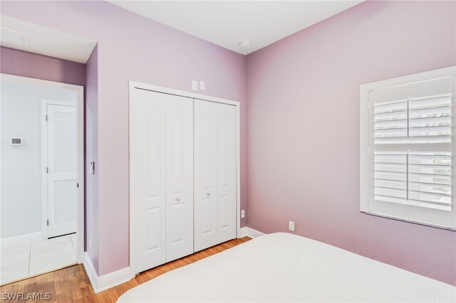 bedroom with a closet and hardwood / wood-style floors