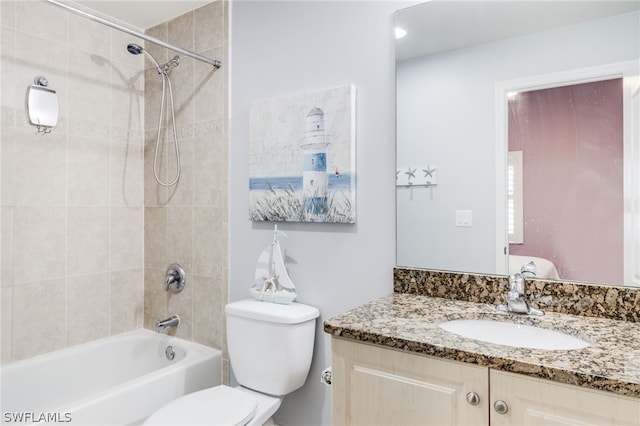 full bathroom with toilet, vanity, and tiled shower / bath