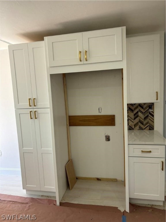 kitchen featuring light hardwood / wood-style floors and white cabinets