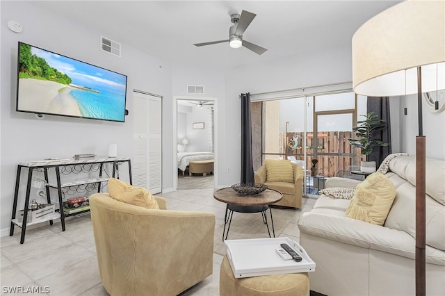 living room featuring light tile patterned floors and ceiling fan