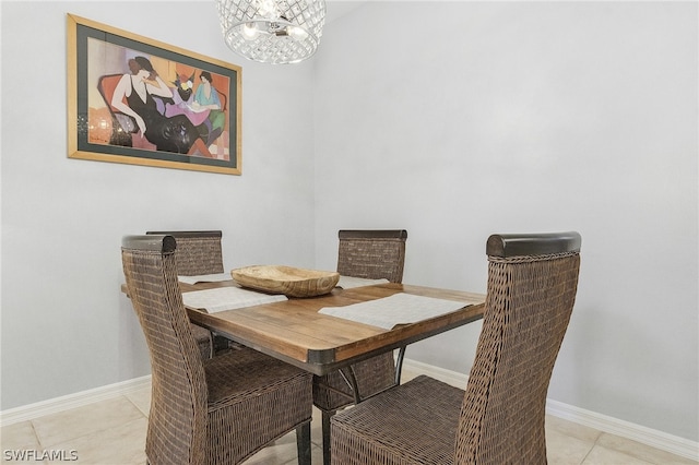 dining space with an inviting chandelier and light tile patterned floors