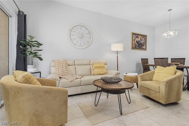 tiled living room with a notable chandelier