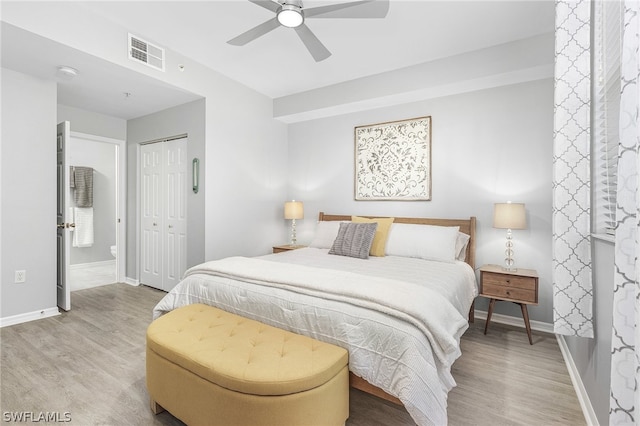 bedroom with ceiling fan, a closet, and light hardwood / wood-style floors