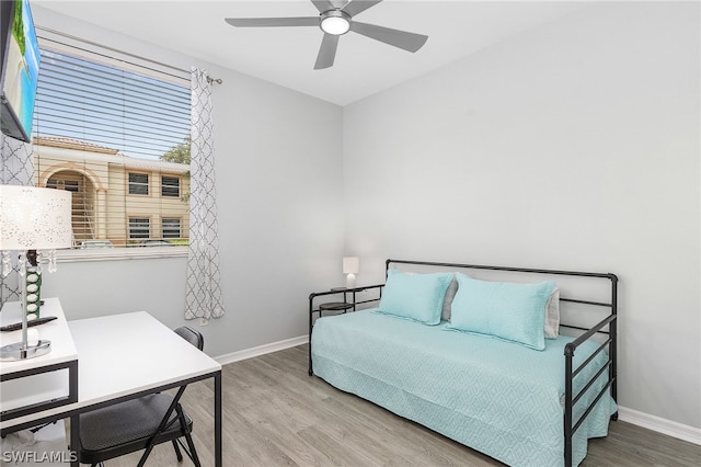 bedroom with ceiling fan and hardwood / wood-style flooring