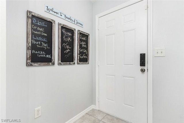 doorway to outside with light tile patterned floors