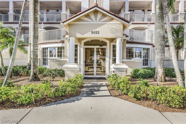 entrance to property featuring french doors and a balcony