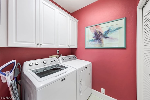 clothes washing area with washer hookup, washing machine and clothes dryer, and cabinets