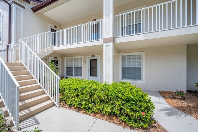 view of exterior entry featuring a balcony