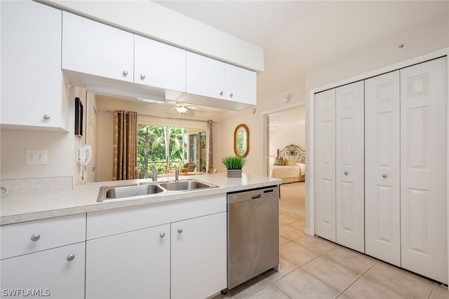 kitchen with ceiling fan, sink, dishwasher, light tile flooring, and white cabinetry