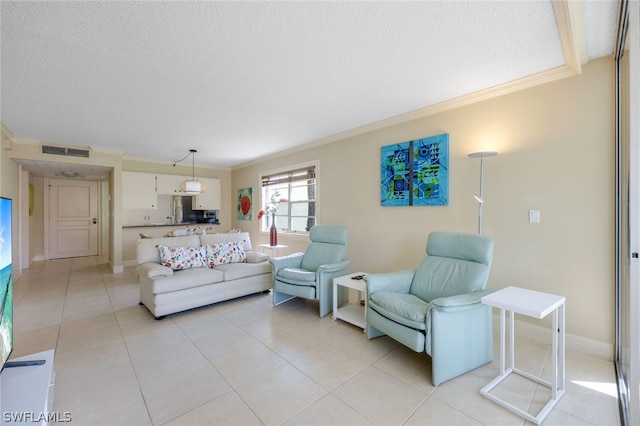 tiled living room featuring ornamental molding and a textured ceiling