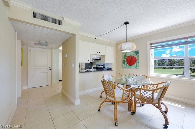 dining space featuring a textured ceiling, crown molding, and light tile floors