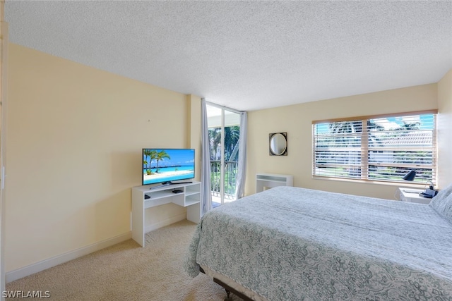 carpeted bedroom featuring a textured ceiling