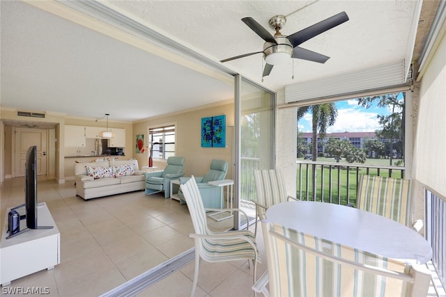 sunroom featuring ceiling fan