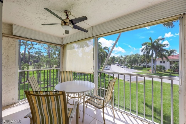 sunroom / solarium featuring ceiling fan