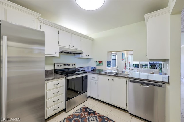 kitchen featuring sink, light tile floors, stainless steel appliances, and white cabinetry