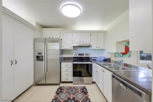 kitchen with sink, stainless steel appliances, white cabinets, and light tile floors