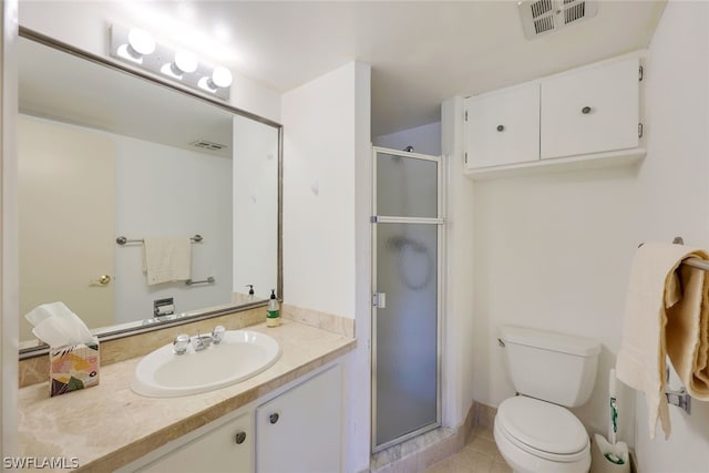 bathroom with tile floors, vanity, toilet, and walk in shower