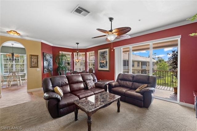 living room with ornamental molding, ceiling fan with notable chandelier, and light carpet